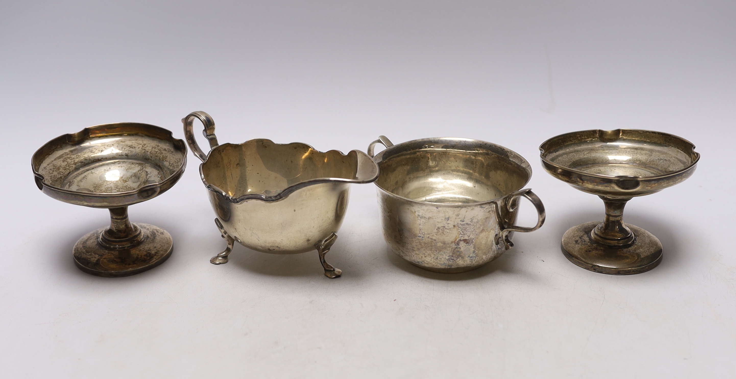 An Elizabeth II silver sauceboat, by Harrods Ltd, a silver two handled bowl and a pair of silver mounted pedestal bonbon dishes.